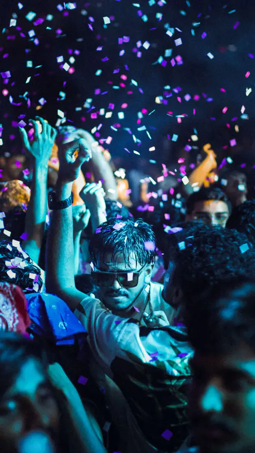 Crowd under confetti at a Goa club night